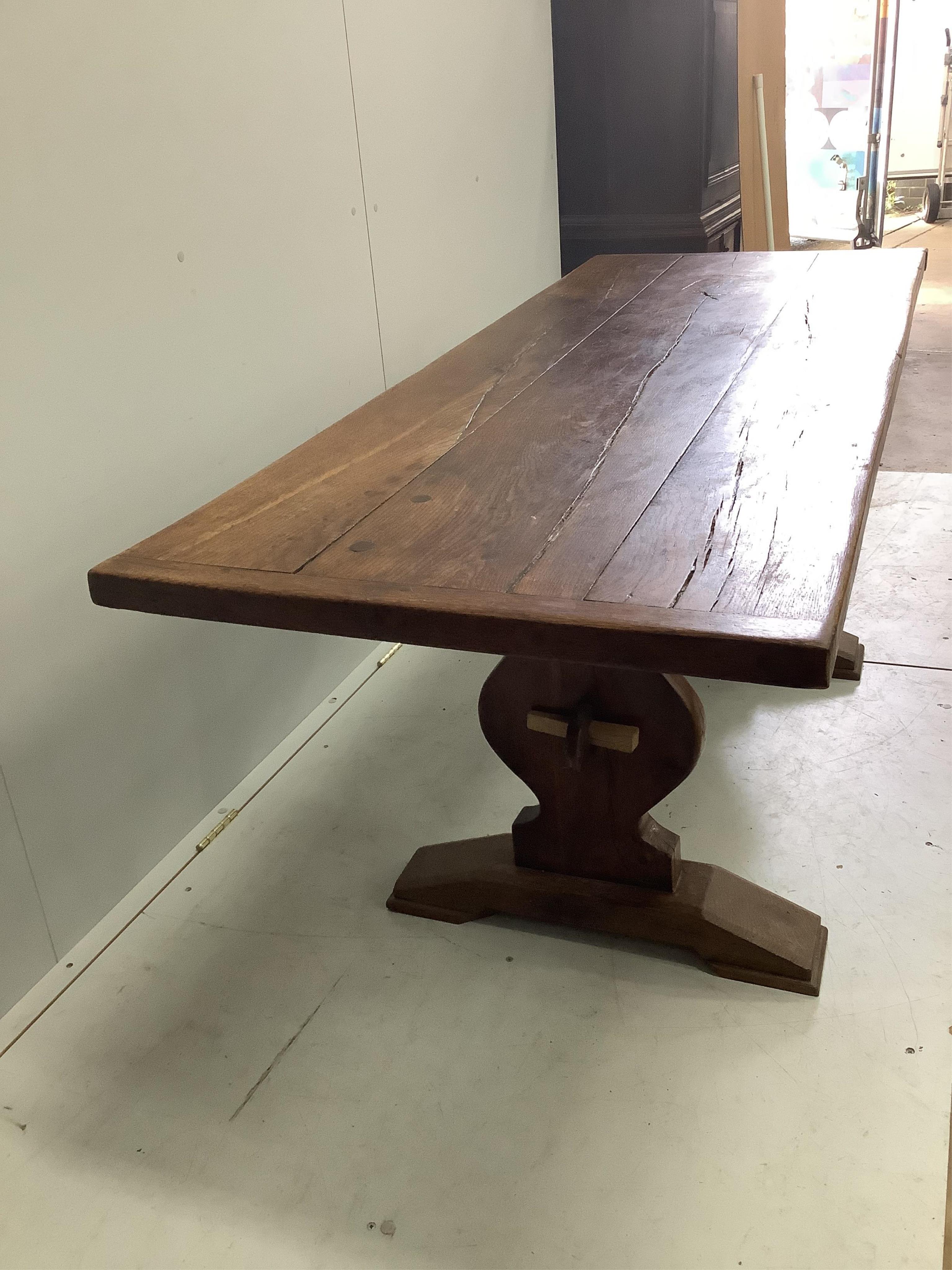 An 18th century style rectangular oak refectory dining table, on shaped end standards, width 176cm, depth 68cm, height 74cm. Condition - fair